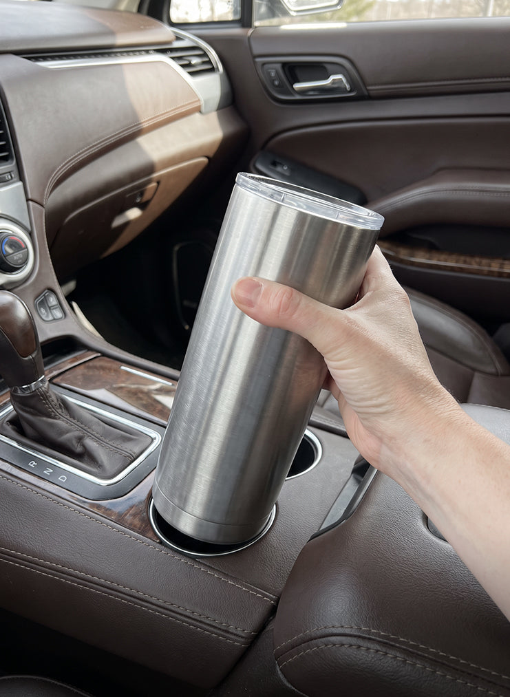 Large bottle next to car cup holder